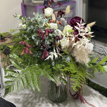 A vase filled with flowers on top of a table.