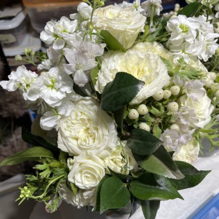 A bouquet of white flowers on top of a table.