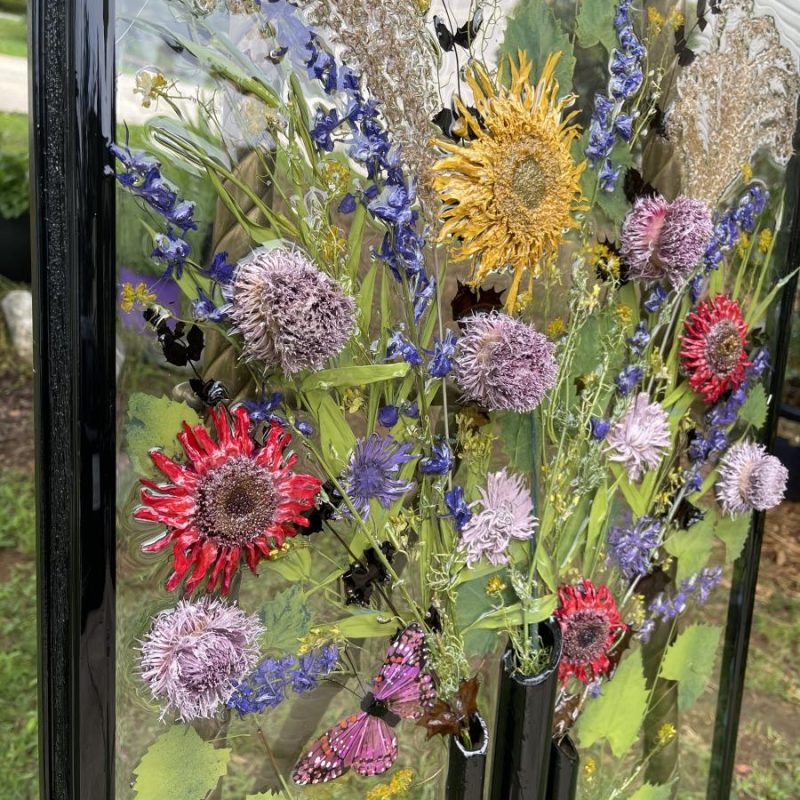 A glass case with flowers on it